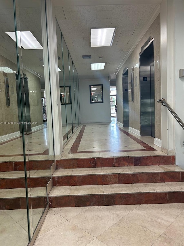 interior space featuring elevator and crown molding