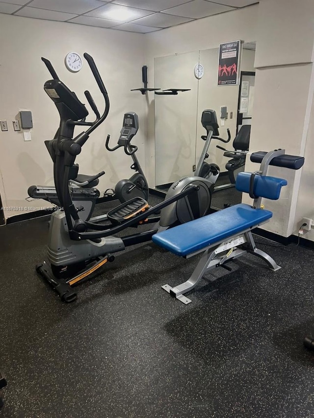 gym with a paneled ceiling