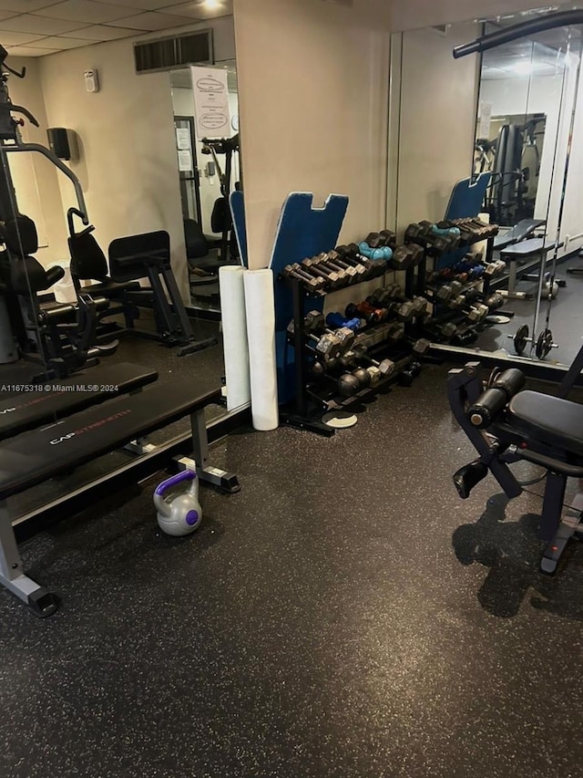 gym featuring a paneled ceiling