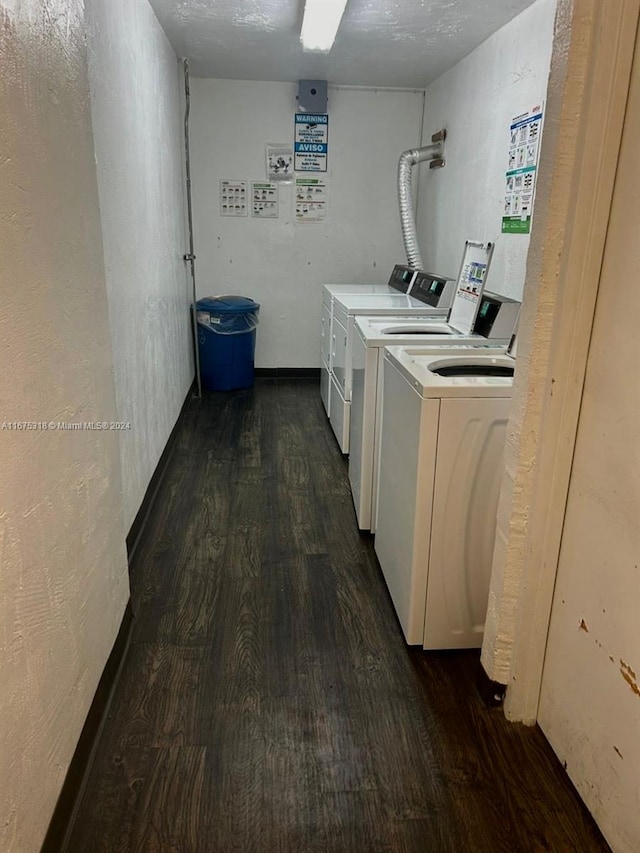 laundry area with washer and dryer, dark hardwood / wood-style flooring, and a textured ceiling