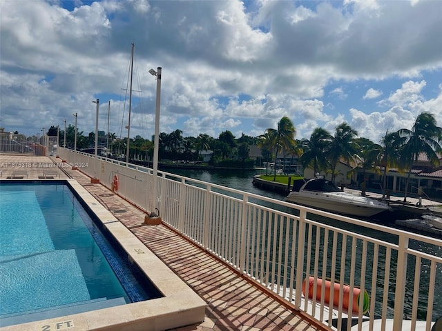 view of pool featuring a water view