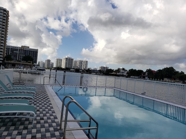 view of swimming pool featuring a water view