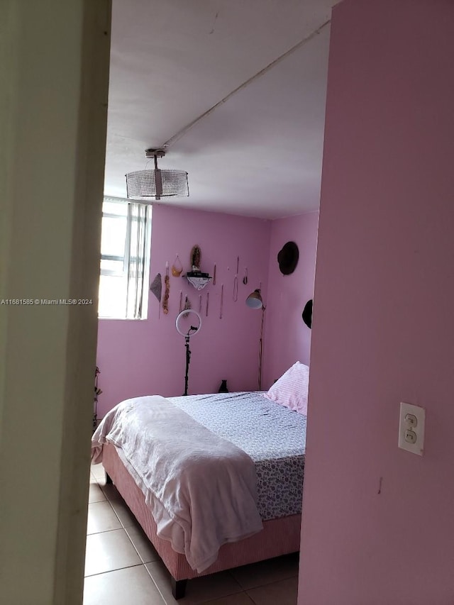 bedroom with light tile patterned floors