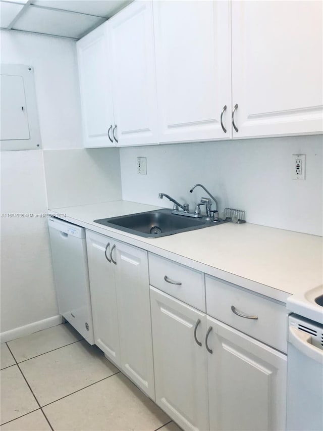 kitchen featuring dishwasher, sink, light tile patterned floors, electric panel, and white cabinets