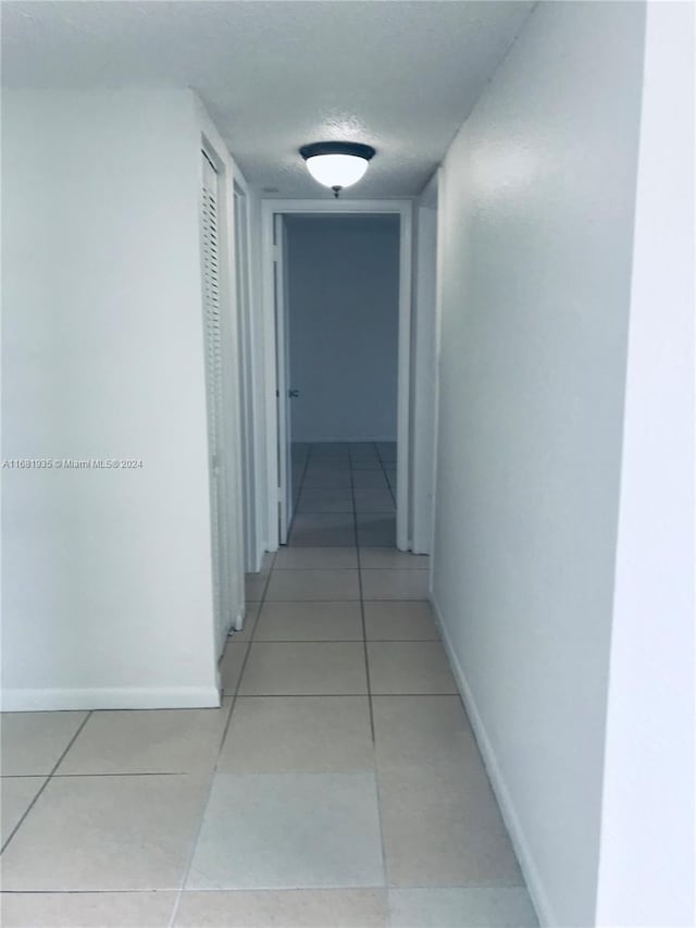 hallway with light tile patterned floors