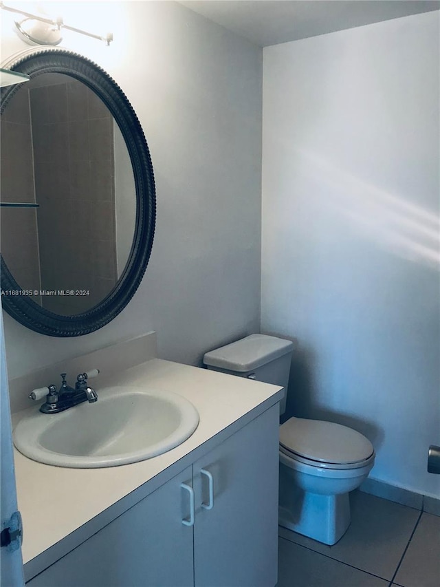 bathroom with vanity, toilet, and tile patterned flooring