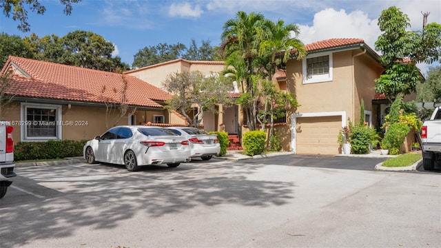 mediterranean / spanish-style home with a garage