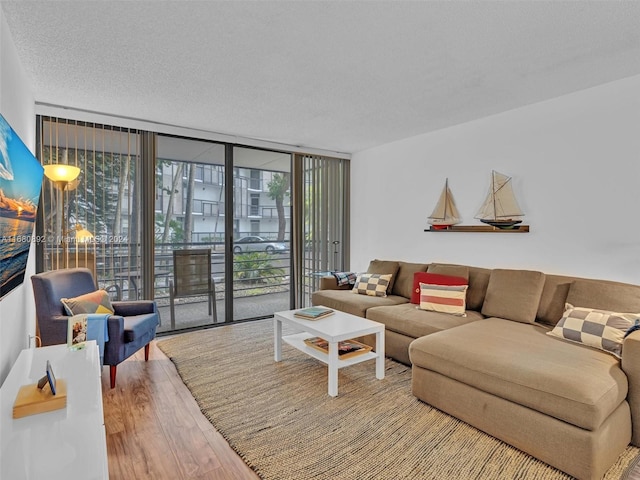 living room with hardwood / wood-style floors, a textured ceiling, and floor to ceiling windows