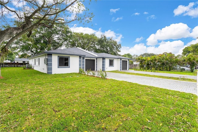 ranch-style home with a garage and a front lawn