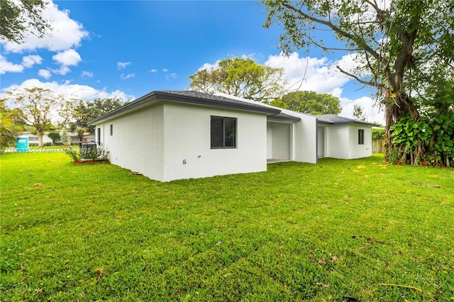 back of property featuring a lawn