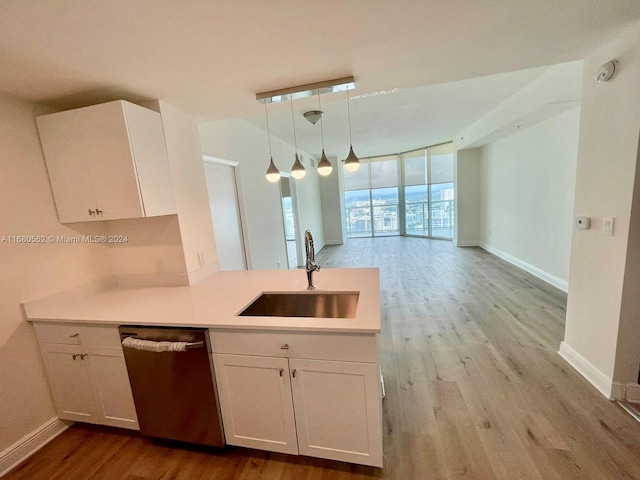 kitchen featuring hanging light fixtures, sink, stainless steel dishwasher, white cabinets, and light hardwood / wood-style floors