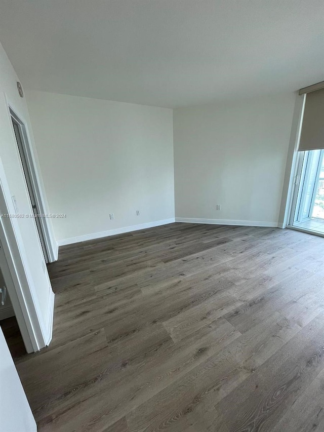 spare room with dark hardwood / wood-style flooring