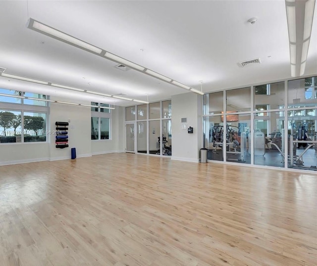 workout area featuring light wood-type flooring