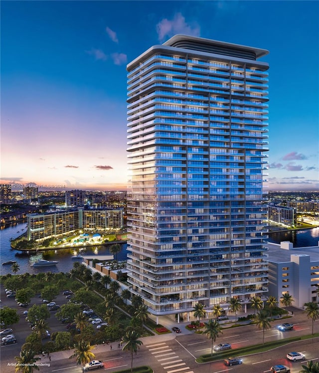 outdoor building at dusk featuring a water view