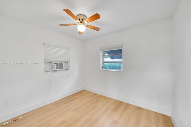 unfurnished room featuring ceiling fan, cooling unit, and light wood-type flooring