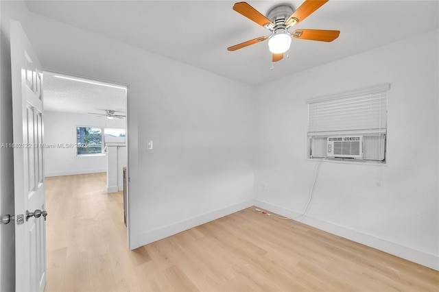 spare room featuring light hardwood / wood-style floors and cooling unit