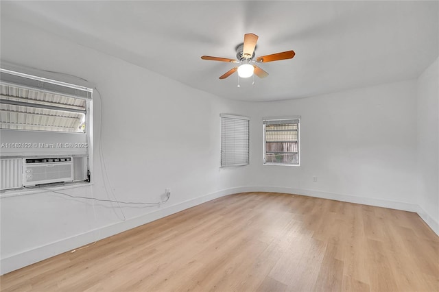 spare room featuring light hardwood / wood-style flooring, ceiling fan, and cooling unit