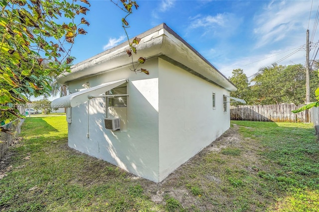 view of side of home with a yard