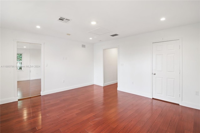 empty room with dark wood-type flooring