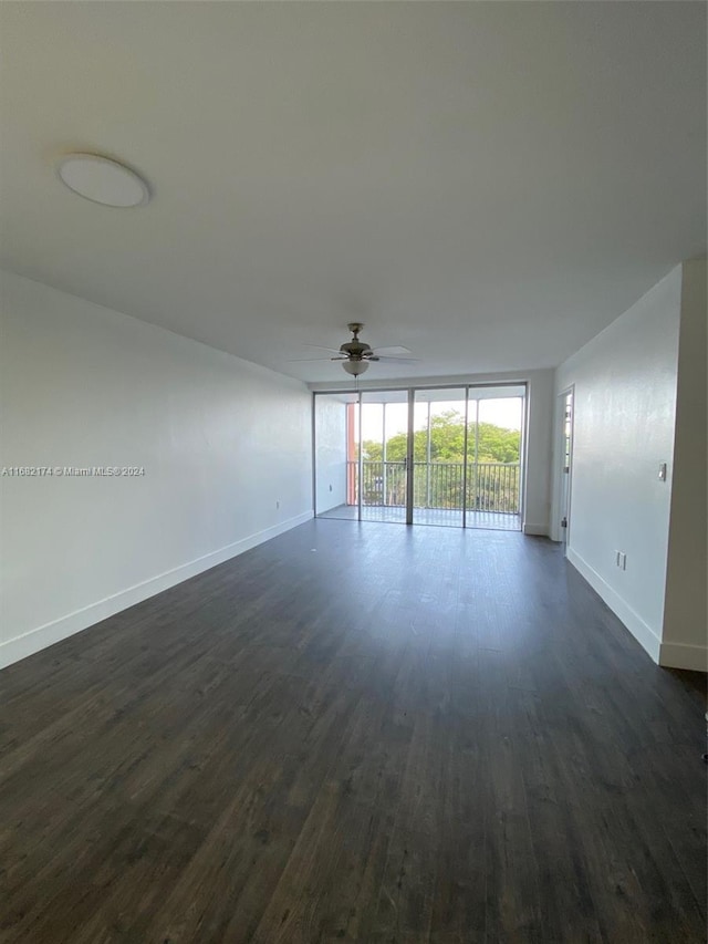 spare room featuring dark hardwood / wood-style floors and ceiling fan