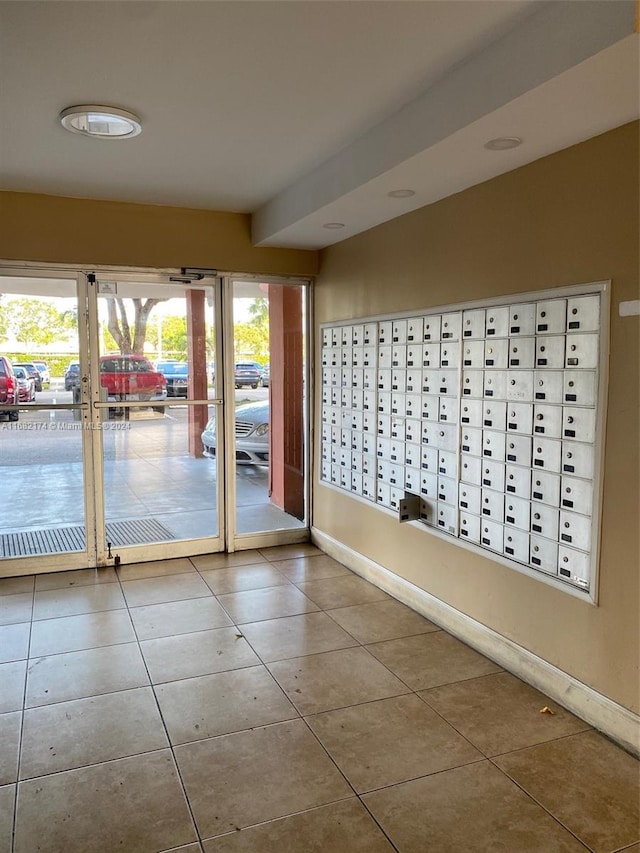 doorway featuring a wealth of natural light, tile patterned flooring, and mail boxes