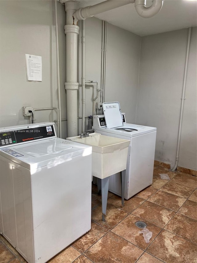 clothes washing area featuring washer and dryer and sink