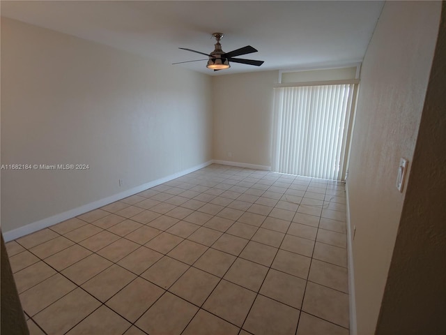 tiled spare room with ceiling fan