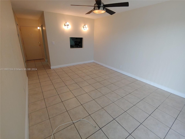 empty room with light tile patterned flooring and ceiling fan