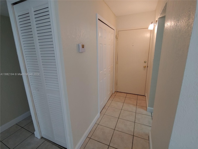 corridor featuring light tile patterned floors