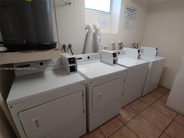 washroom with washer and dryer and light tile patterned floors