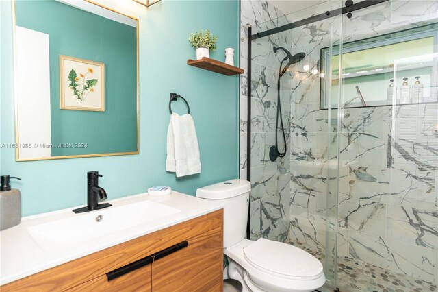 bathroom featuring vanity, toilet, and an enclosed shower