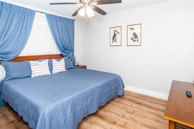 bedroom with ceiling fan and wood-type flooring