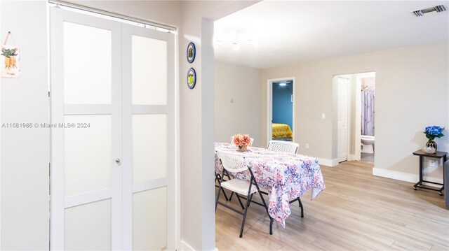 dining space with light hardwood / wood-style flooring