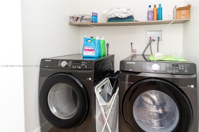 clothes washing area with washer and clothes dryer