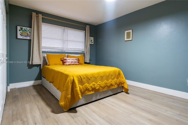 bedroom with light hardwood / wood-style floors