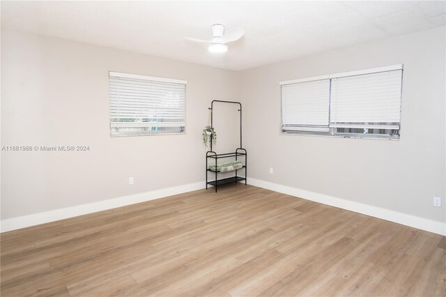 unfurnished room with light wood-type flooring and ceiling fan