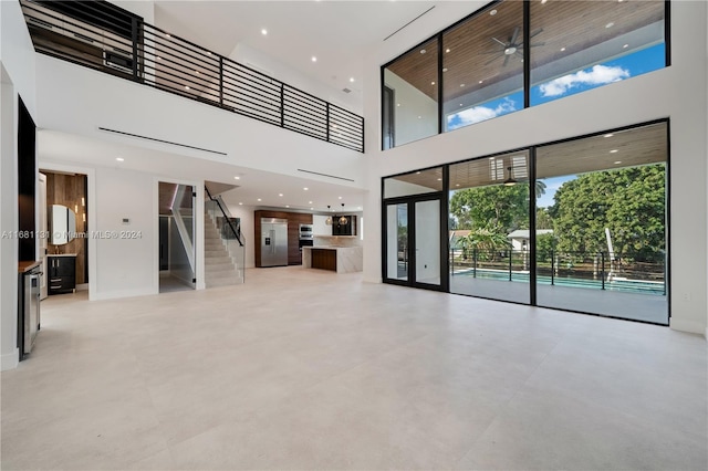 unfurnished living room with a high ceiling