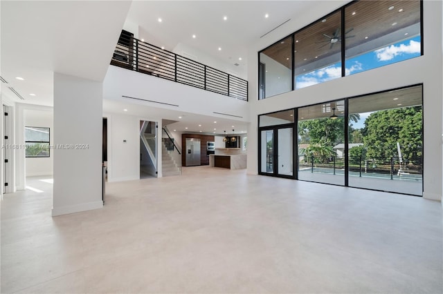 unfurnished living room with a high ceiling