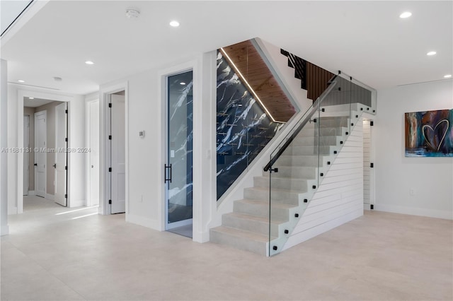 stairs with concrete floors