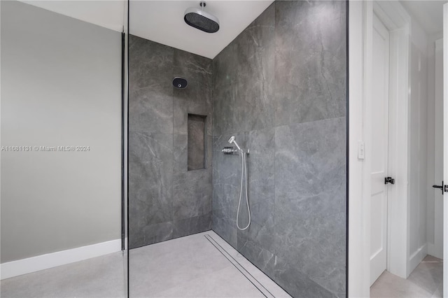 bathroom with a tile shower