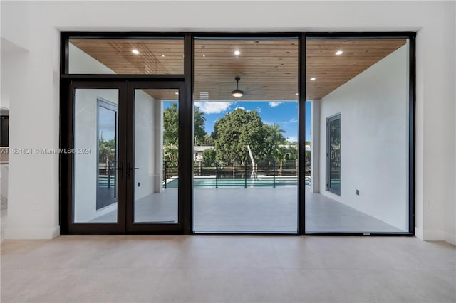 doorway to outside featuring expansive windows, wood ceiling, and french doors