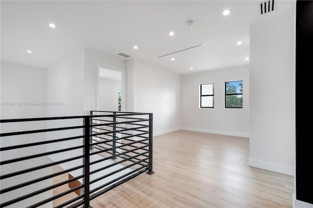 corridor with light hardwood / wood-style flooring