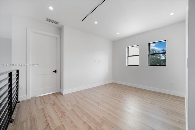 empty room with light hardwood / wood-style floors