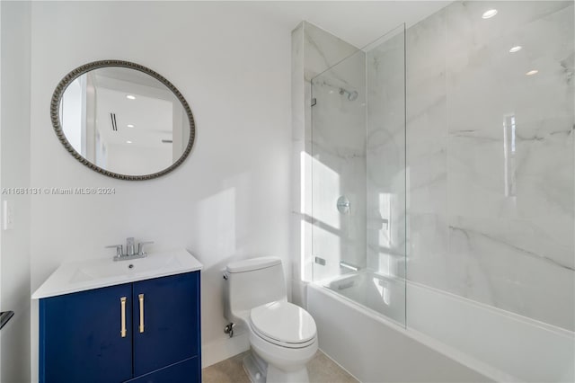 full bathroom with vanity, tiled shower / bath combo, and toilet