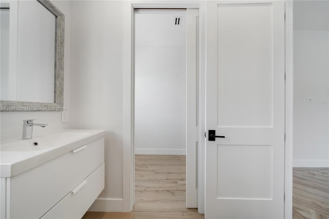 bathroom featuring vanity and hardwood / wood-style flooring