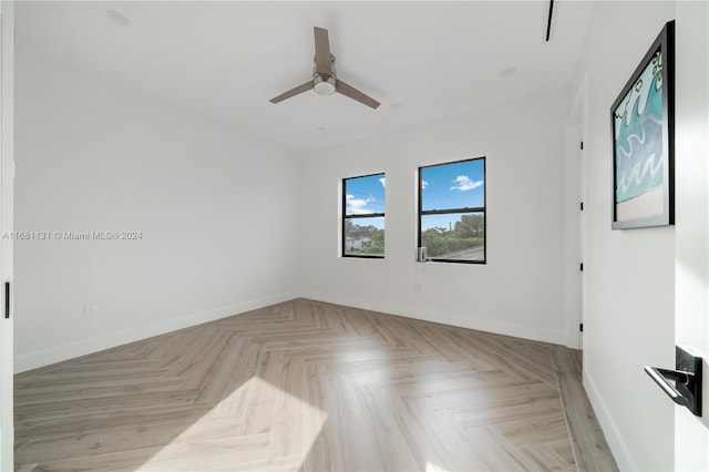 unfurnished room with light parquet floors and ceiling fan