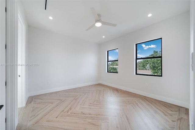 empty room featuring ceiling fan and light parquet flooring