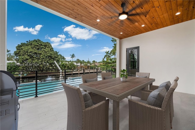 view of patio featuring a grill, ceiling fan, and a water view