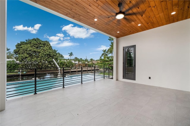 view of patio / terrace with ceiling fan and a water view