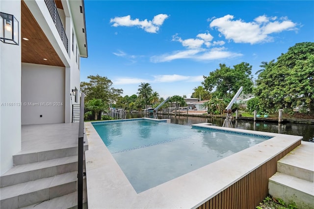 view of swimming pool with a water view